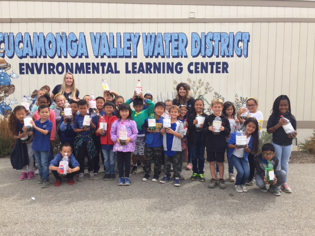 Young students taking a picture in front of Environmental Learning Center
